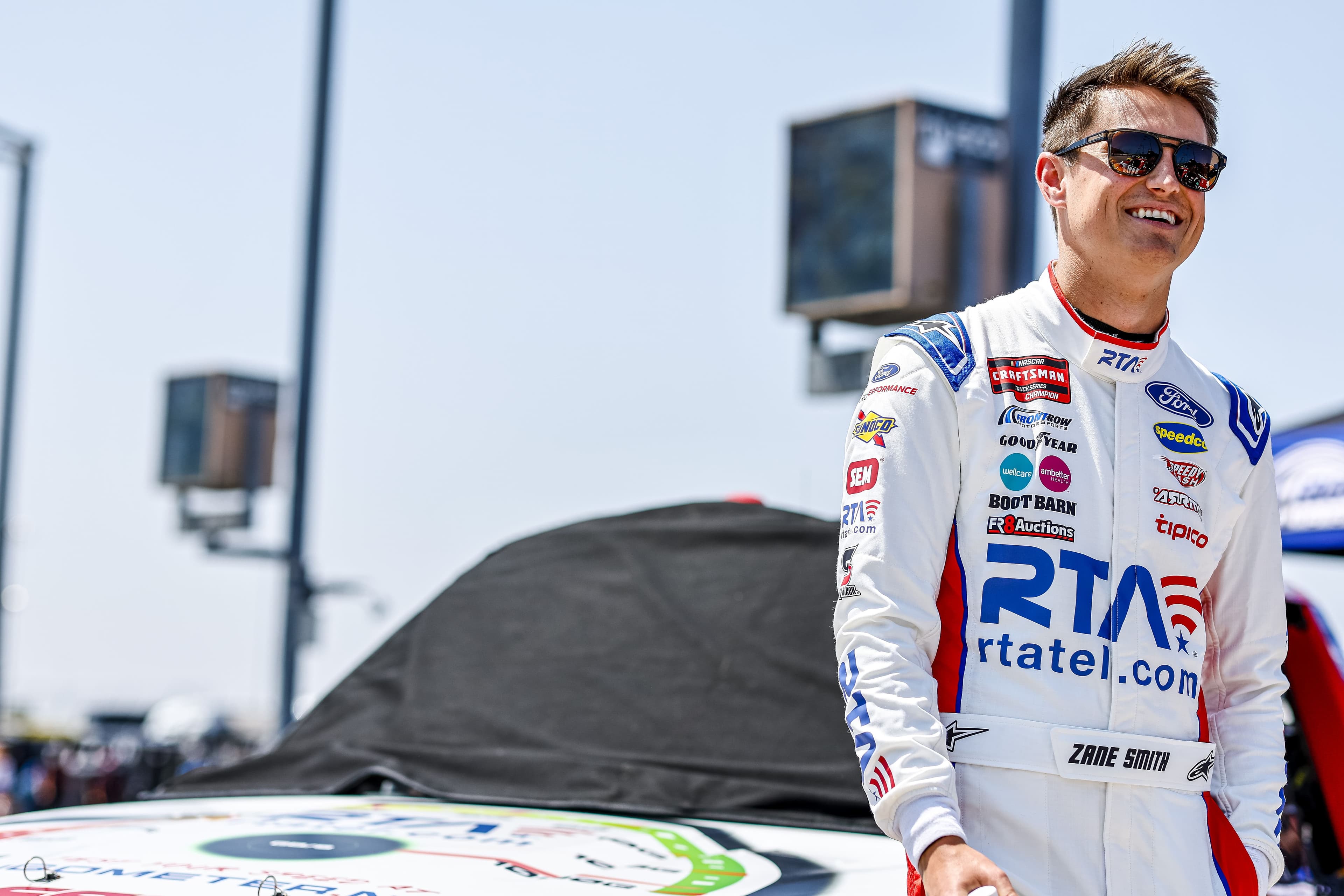 Zane Smith at trackside, RTA rtatel.com prominently displayed on racing suit
