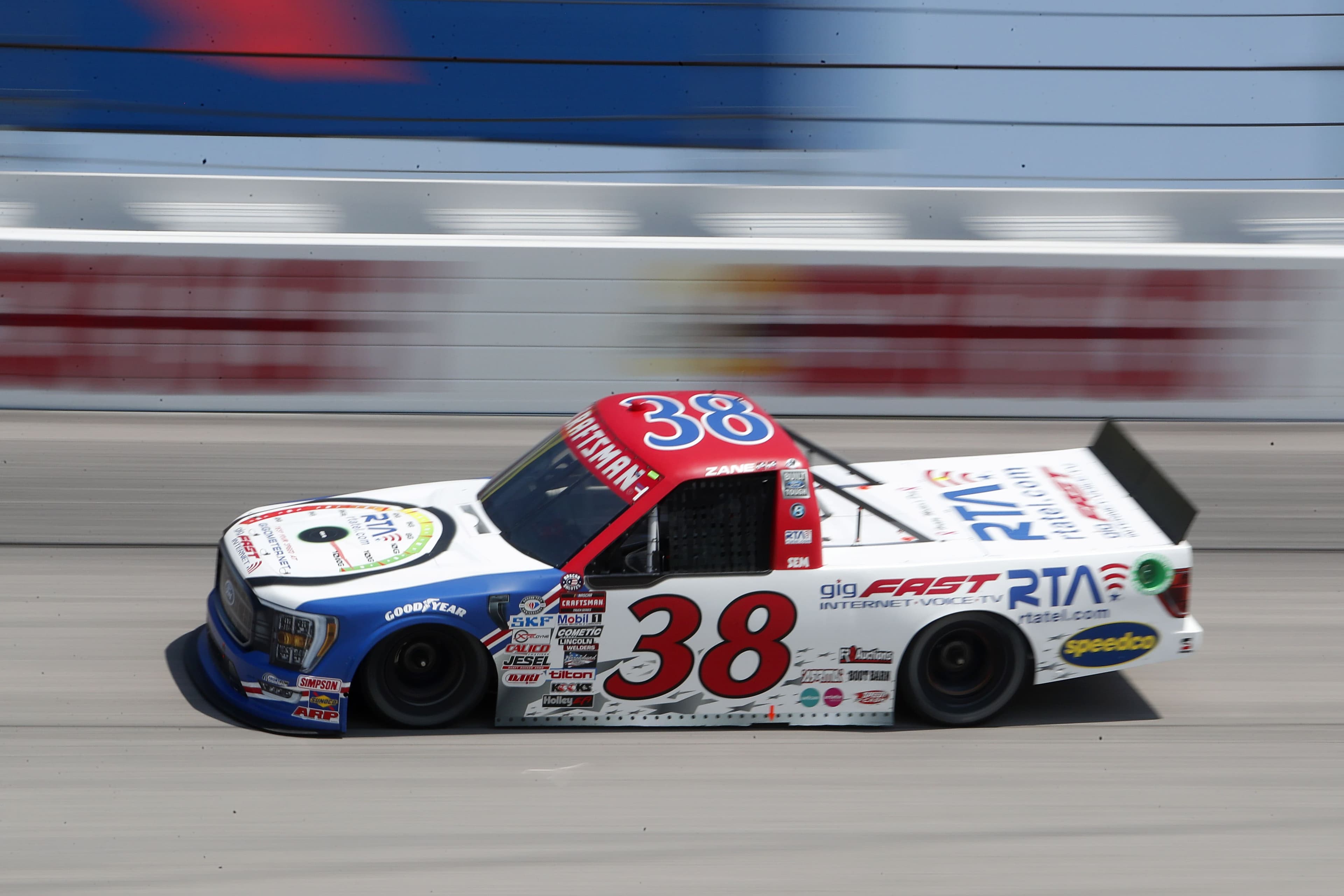 #38 Ford F-150 truck in motion, daytime, gigFAST and RTA logos clearly legible on side